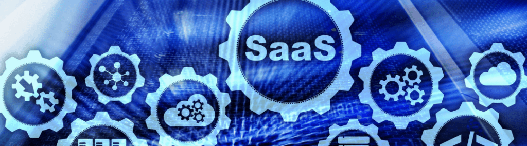 The word SaaS and software icons in gears on computer screen background